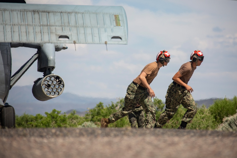 Aviation Ordnanceman mount LAU-61 G/A Digital Rocket Launcher onto an MH-60S