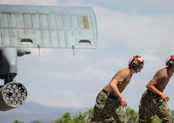 Aviation Ordnanceman mount LAU-61 G/A Digital Rocket Launcher onto an MH-60S