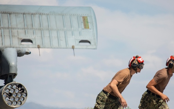 Aviation Ordnanceman mount LAU-61 G/A Digital Rocket Launcher onto an MH-60S