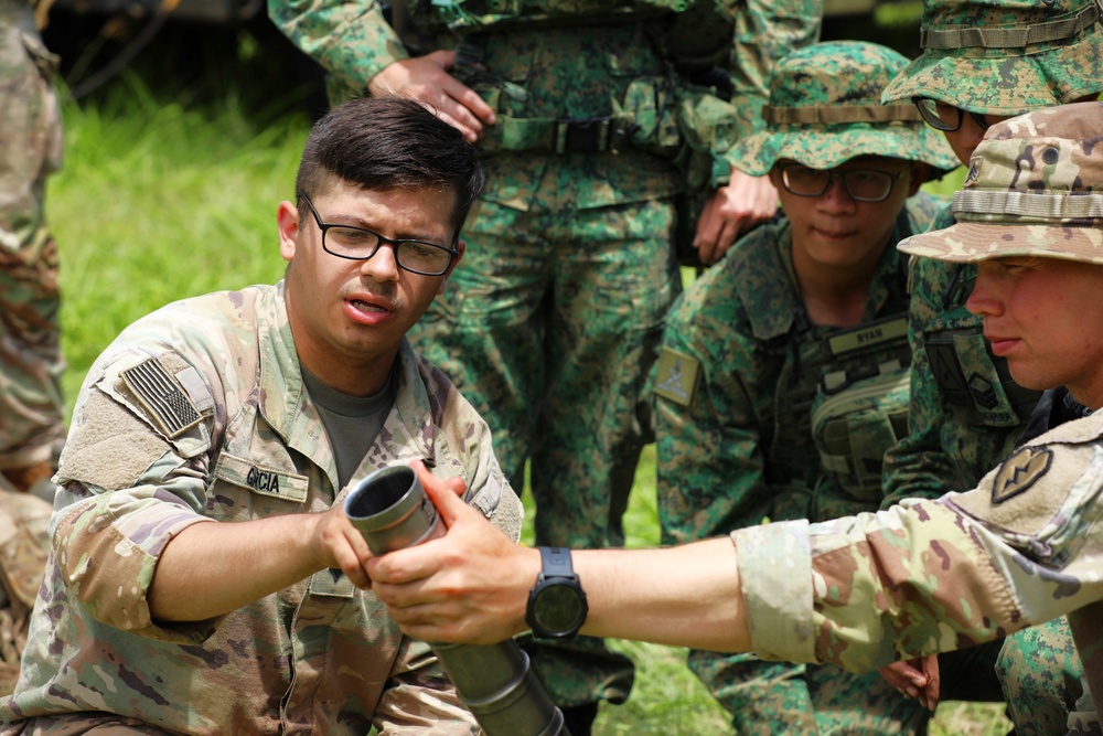 Soldiers assigned to 25th Infantry Division show Singapore Army soldiers the tactics, techniques, &amp; procedures they use when firing mortars during TigerBalm23