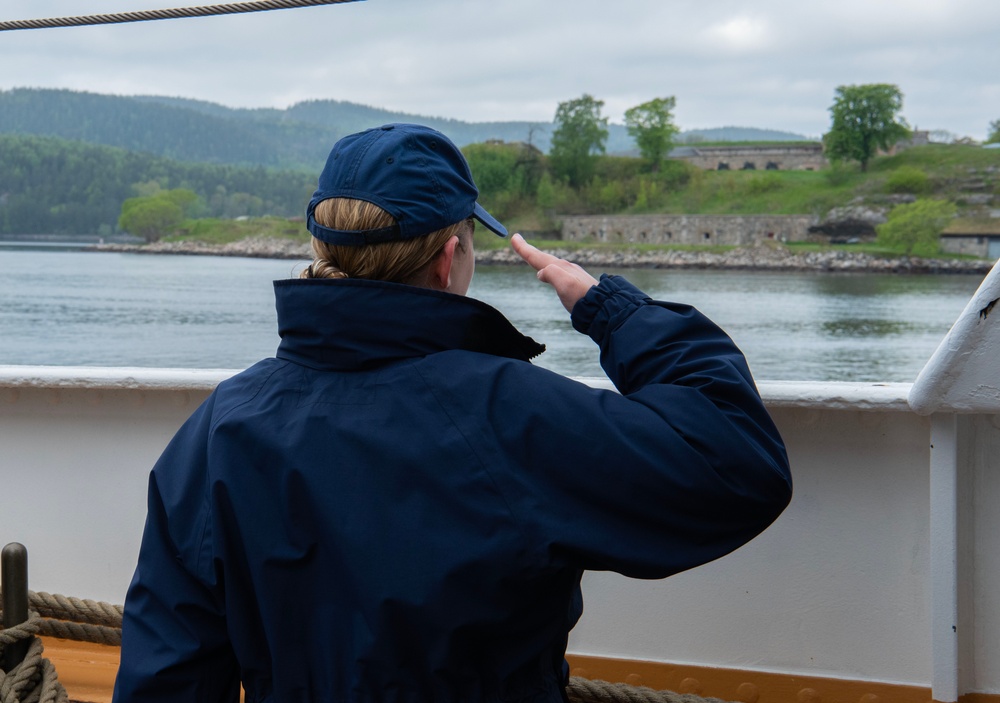 USCGC Eagle crew members render honors to Oscarsborg Fortress in Norway