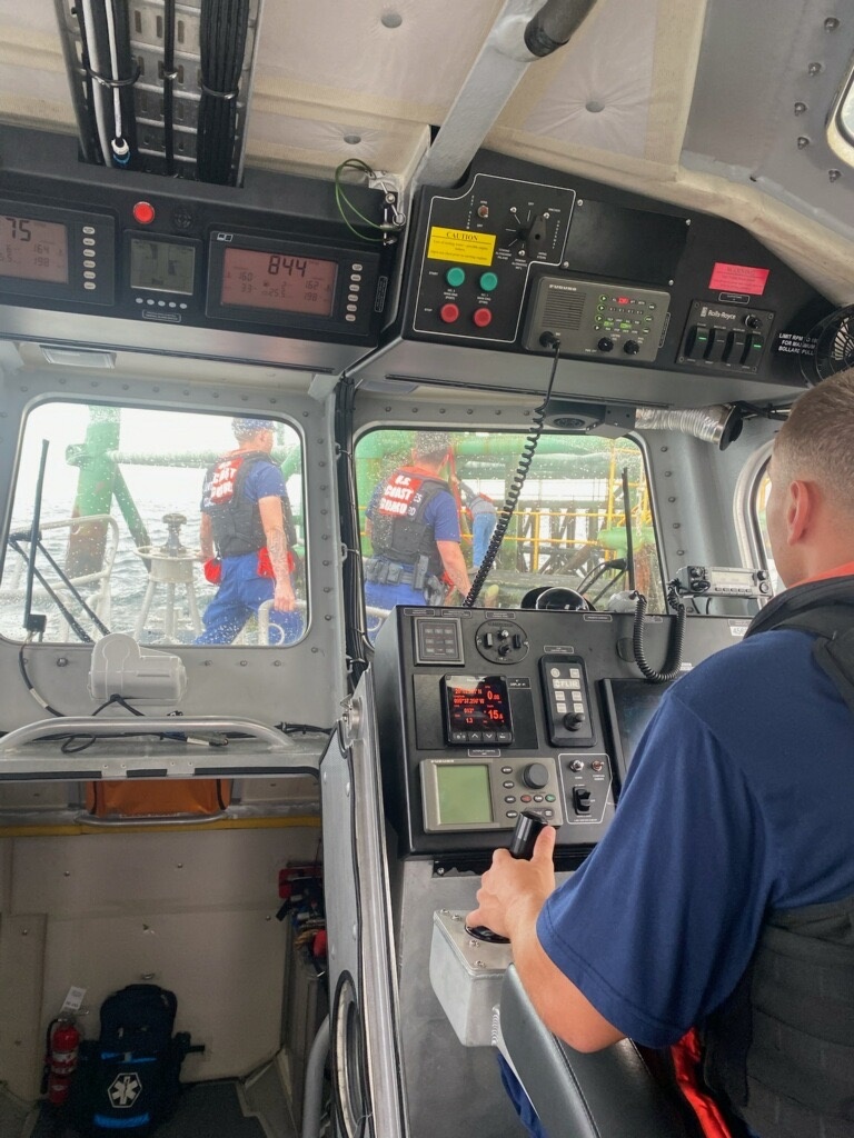 A Coast Guard Station Freeport 45-foot Response Boat-Medium boatcrew rescues three boaters aboard an oil rig after their vessel began sinking near Freeport, Texas on May 21, 2023. The boatcrew embarked the boaters and transferred them to Surfside Marina in Freeport. (U.S. Coast Guard photo by Station Freeport)