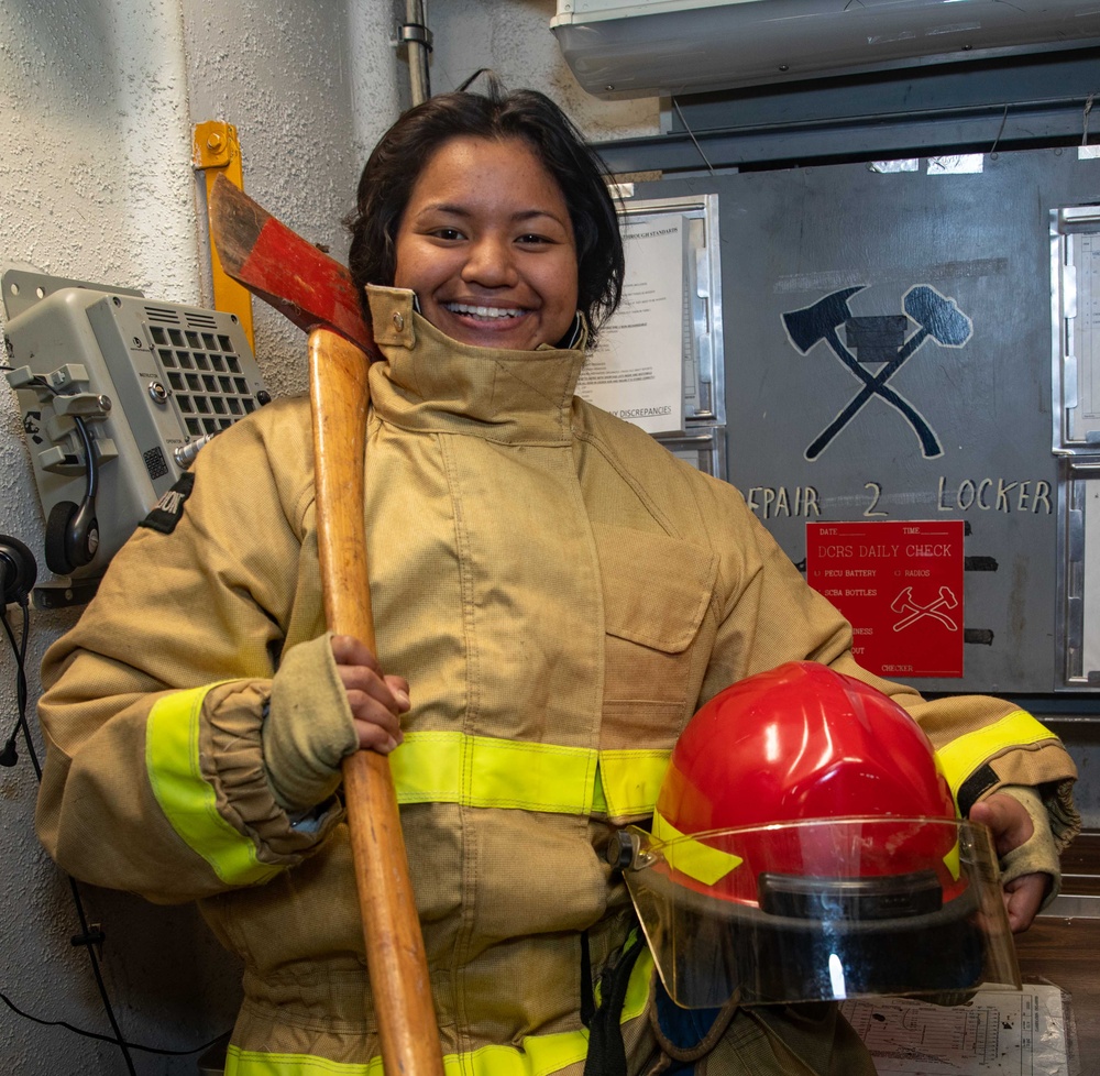 Damage Controlman Fireman Faustita Asano, from Kalihi, Hawaii poses for a photo