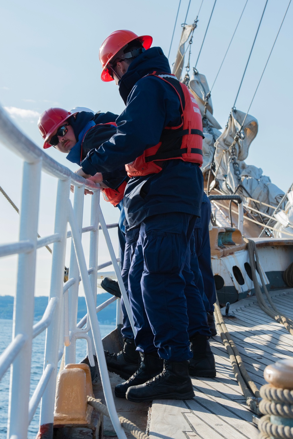 Crew members aboard USCGC Eagle anchor at sea