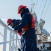 Crew members aboard USCGC Eagle anchor at sea