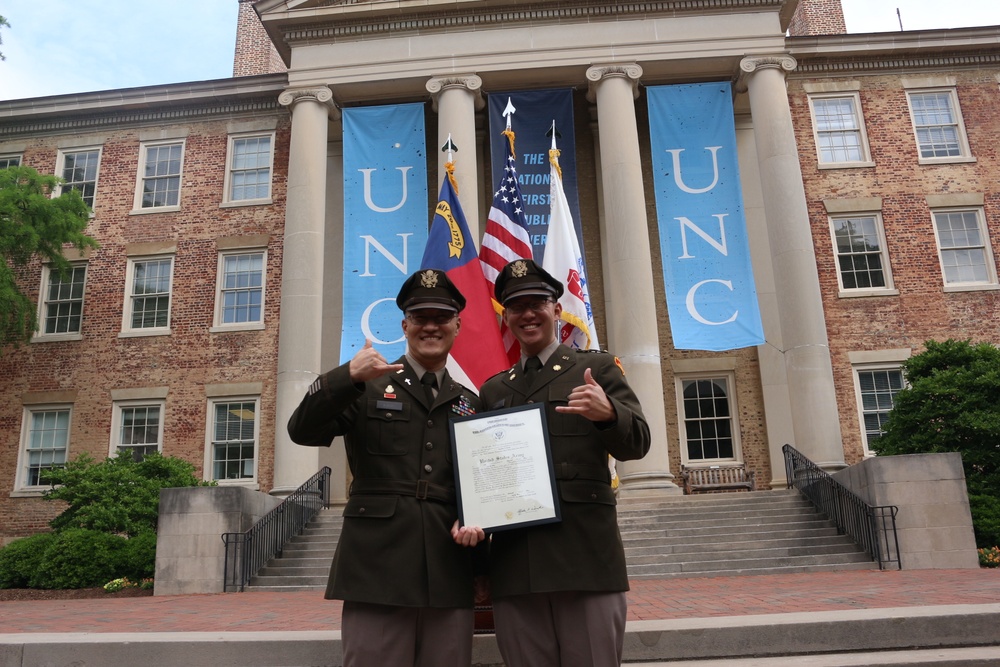 Chaplain administers oath to son during ROTC commissioning ceremony on UNC
