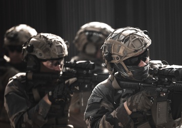 U.S. Marines run through the Outdoor Infantry Immersion Trainer with foreign allied Nations