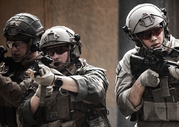 U.S. Marines run through the Outdoor Infantry Immersion Trainer with foreign allied Nations