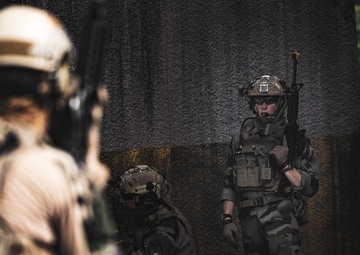 U.S. Marines run through the Outdoor Infantry Immersion Trainer with foreign allied Nations