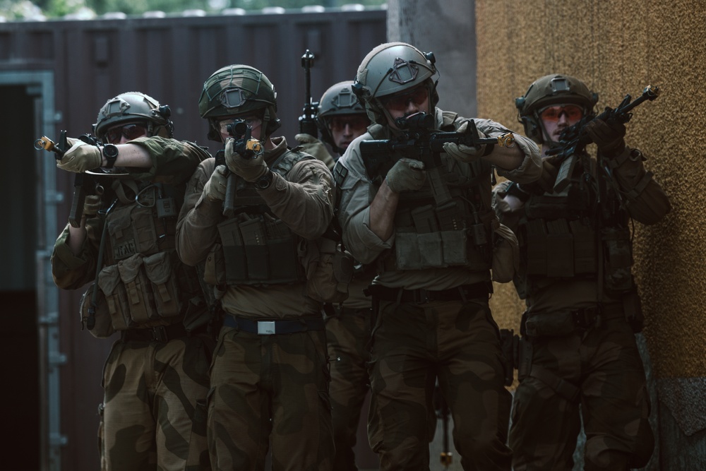 U.S. Marines run through the Outdoor Infantry Immersion Trainer with foreign allied Nations