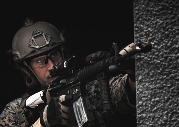 U.S. Marines run through the Outdoor Infantry Immersion Trainer with foreign allied Nations