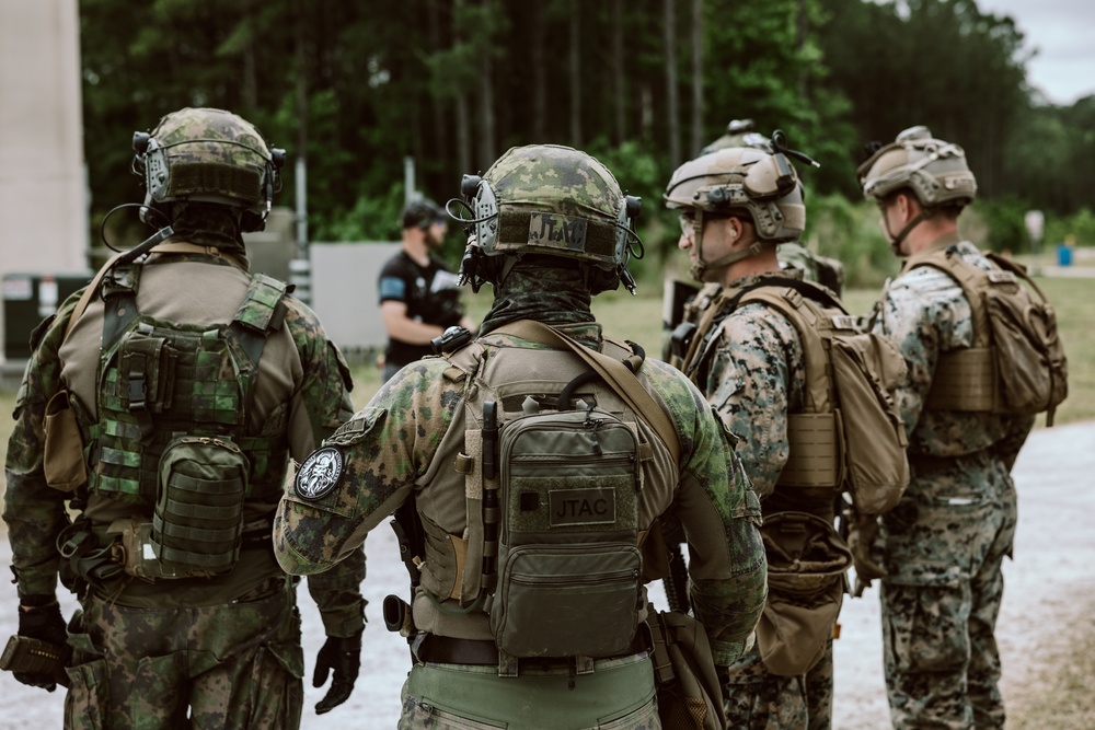 U.S. Marines run through the Outdoor Infantry Immersion Trainer with foreign allied Nations