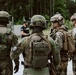 U.S. Marines run through the Outdoor Infantry Immersion Trainer with foreign allied Nations