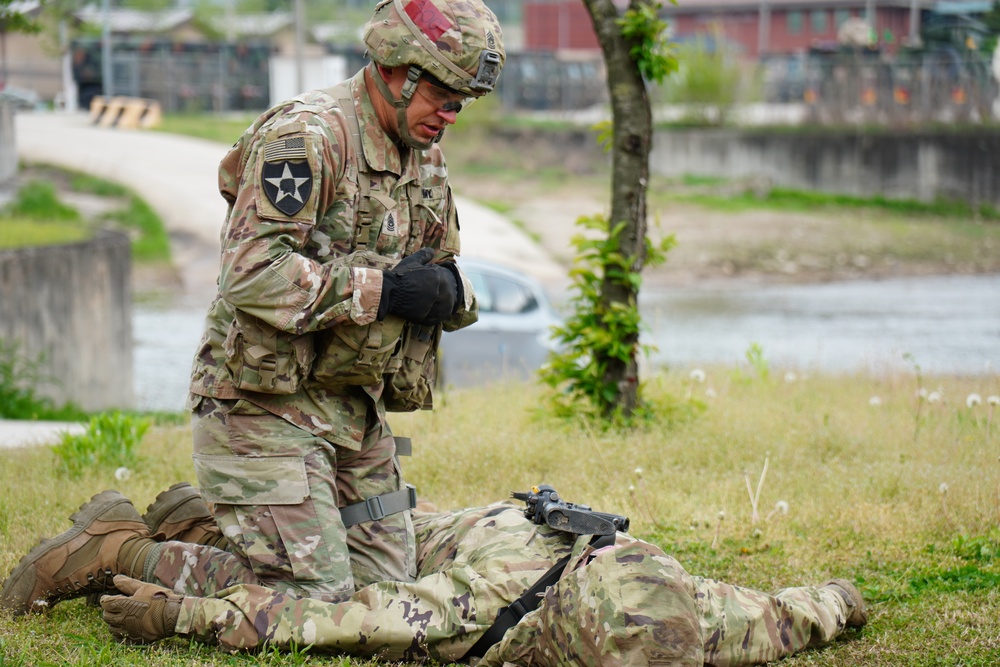 Command Sgt. Maj. Ryan Cole prepares to evacuate a simulated casualty during Expert Field Medical Badge Testing 2023 at Camp Casey, Republic of Korea.