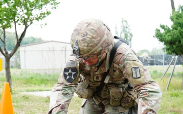 Command Sgt. Maj. Ryan Cole prepares a casualty for buddy-movement