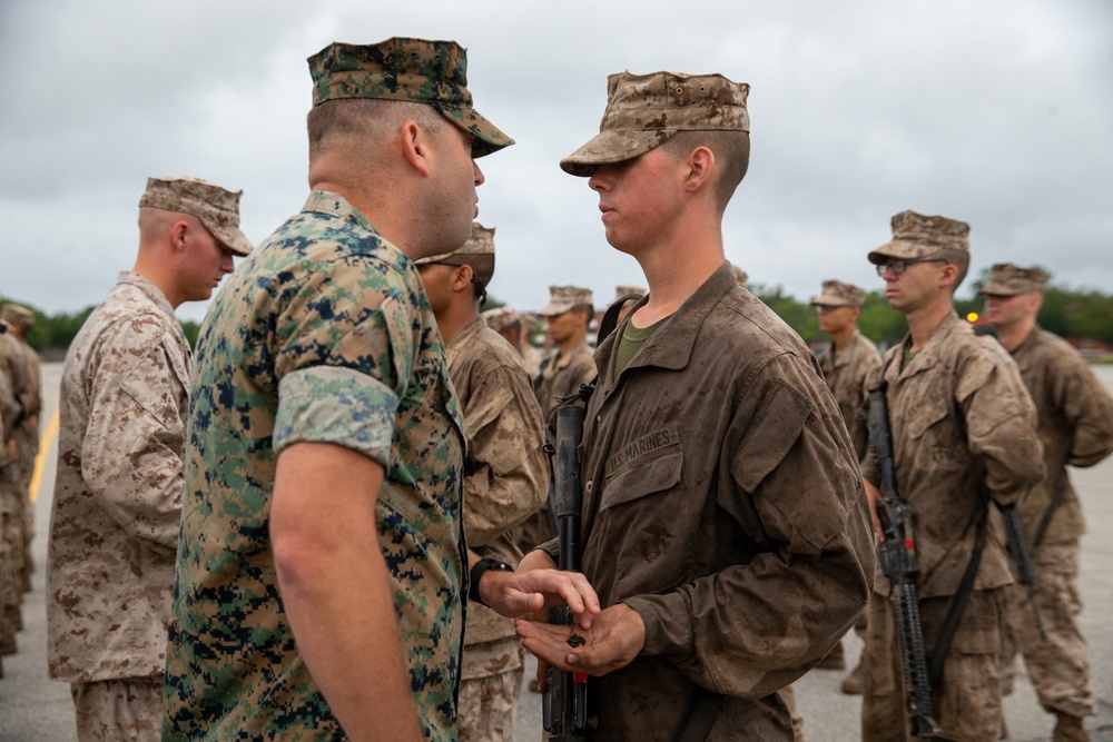 Master Sgt. James C. Orton awards Pvt. Andrew T. Johnson his Eagle, Globe, and Anchor