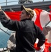 Sailor Lowers Signal Flags Following Port Transit