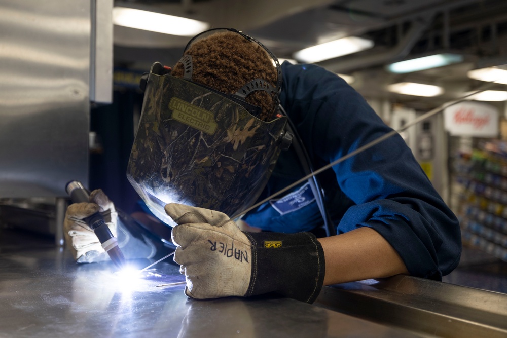 USS Bataan Sailor welds repairs