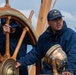 USCGC Eagle crew member helms cutter