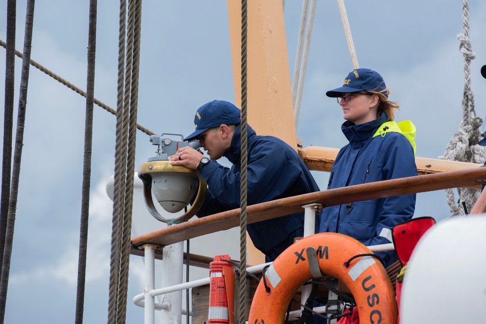 Crew members aboard USCGC Eagle stand watch during transit out of Norwegian waters