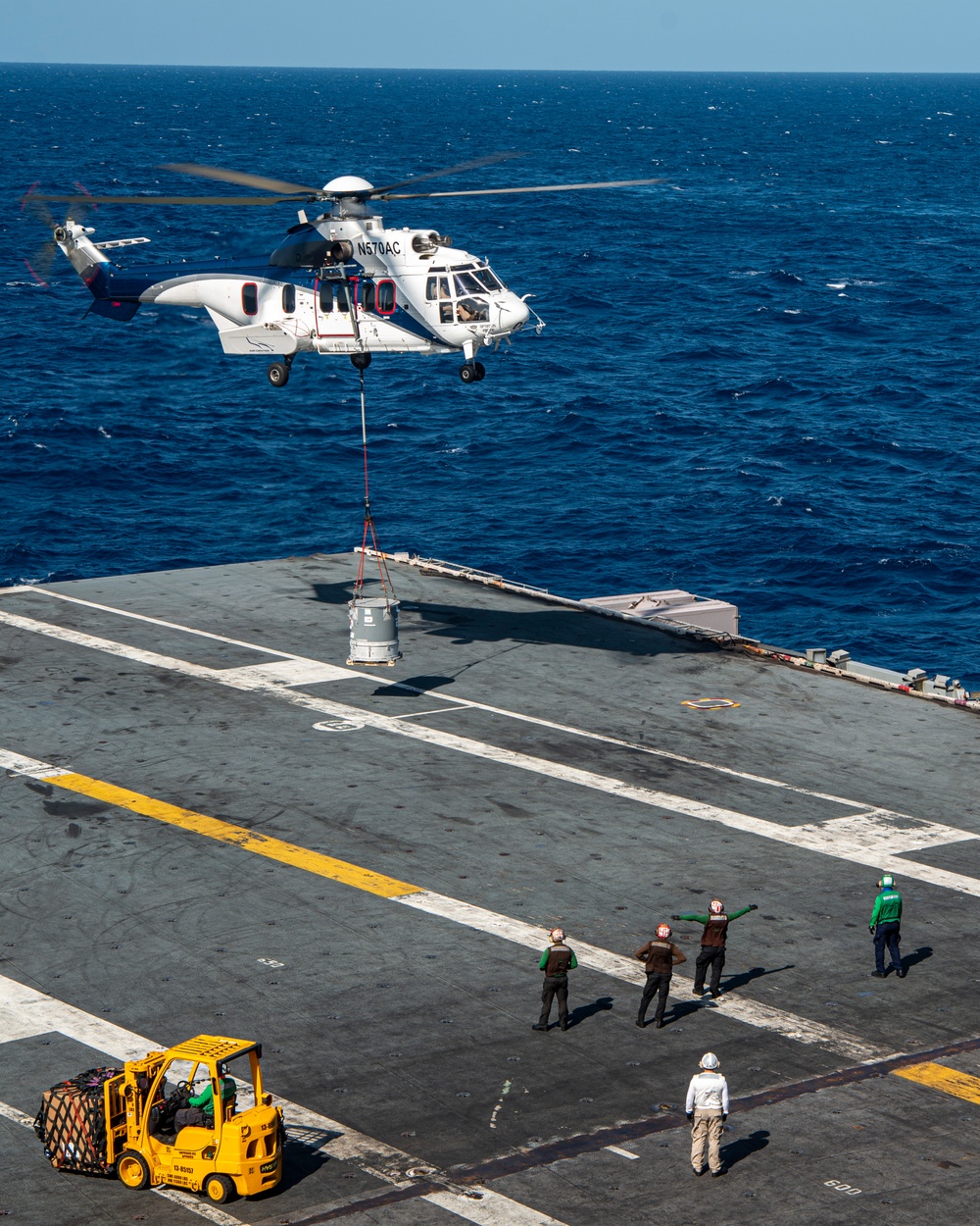 Helicopter Deposits Cargo Onto Flight Deck