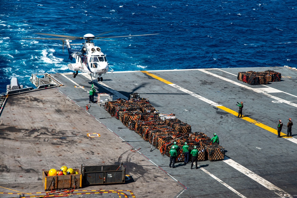 Sailors Load Helicopter with Cargo On The Flight Deck