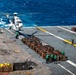 Sailors Load Helicopter with Cargo On The Flight Deck