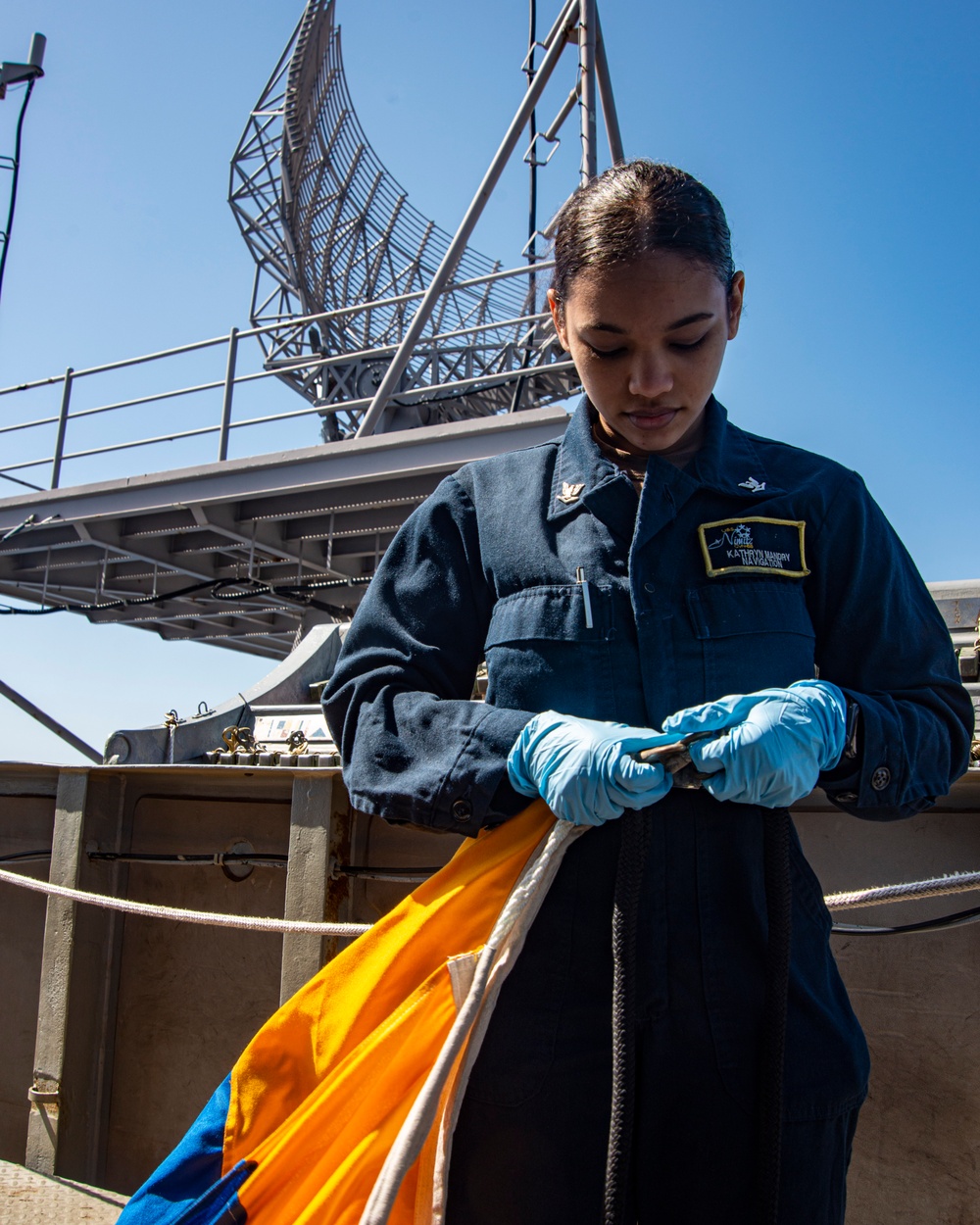 Sailor Prepares To Raise Signal Flag