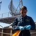 Sailor Prepares To Raise Signal Flag