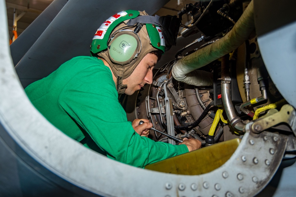 USS Ronald Reagan (CVN 76) Sailors work in the hangar bay