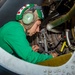 USS Ronald Reagan (CVN 76) Sailors work in the hangar bay