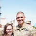 Command Sgt. Maj. Ryan Cole stands with his wife after pinning on his EFMB