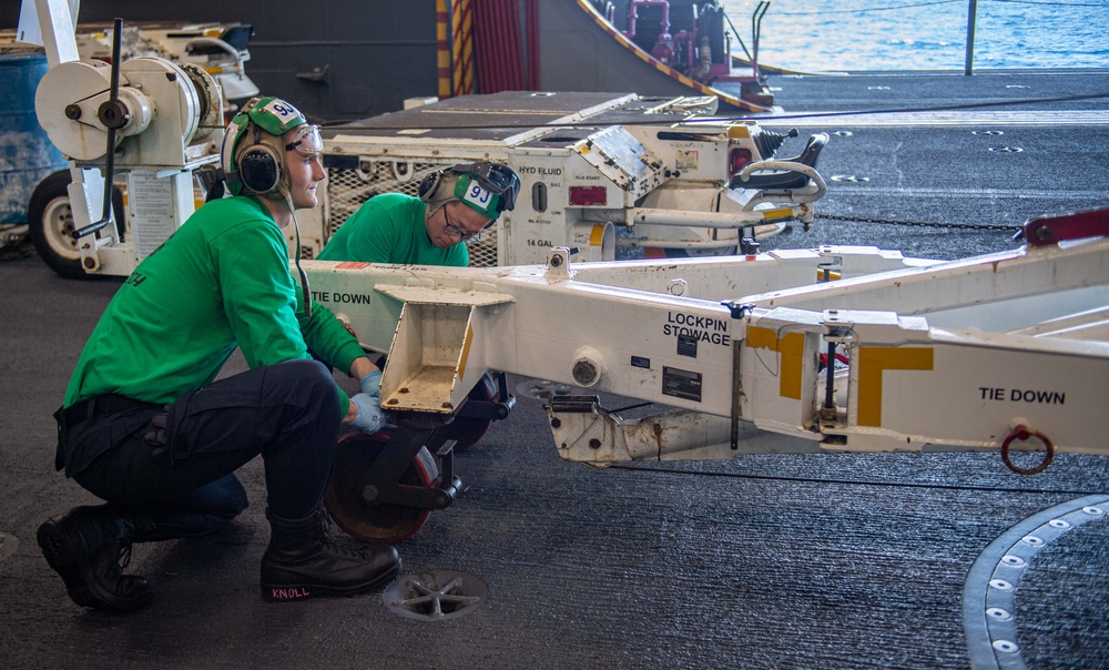 USS Ronald Reagan (CVN 76) Sailors perform maintenance on utility crane