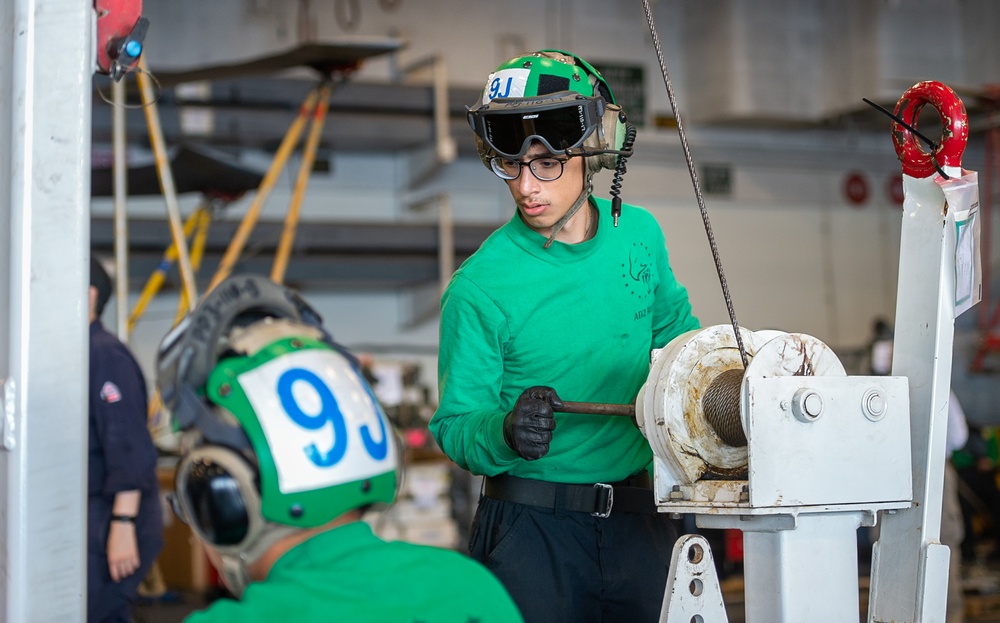 USS Ronald Reagan (CVN 76) Sailors perform maintenance on utility crane