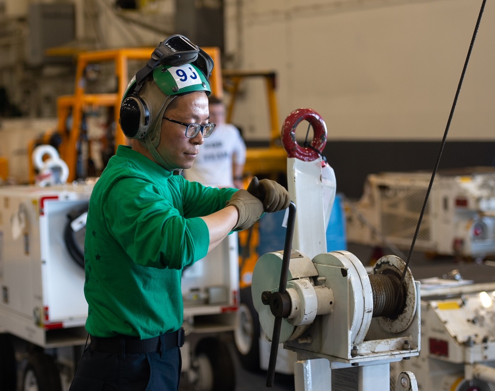 USS Ronald Reagan (CVN 76) Sailors perform maintenance on utility crane