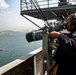 Sailor Mans Ship's Binoculars During Port Transit