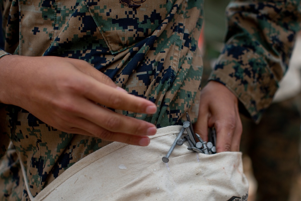 Service members help build houses for veterans