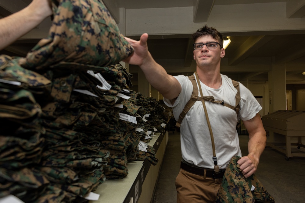 Marine Officer Candidates with Officer Candidate School conduct initial uniform issue on Marine Corps Base Quantico