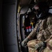 Iowa National Guard crew chief peers out Black Hawk window