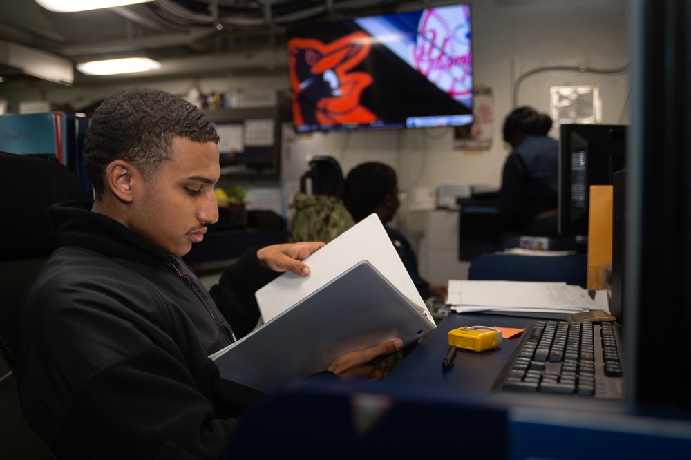 USS Ronald Reagan (CVN 76) Sailors process administrative documents