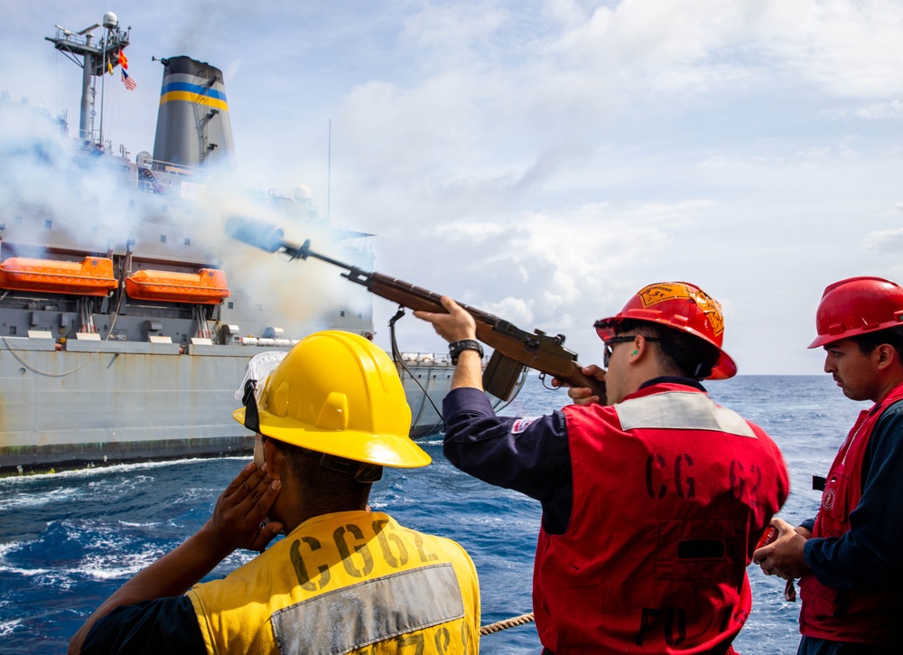 USS Robert Smalls (CG 62) Sailor Shoots Shot Line During RAS with USNS Tippecanoe (T-AO-199)