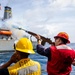 USS Robert Smalls (CG 62) Sailor Shoots Shot Line During RAS with USNS Tippecanoe (T-AO-199)