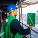 USS Robert Smalls (CG 62) Sailor Signals USNS Tippecanoe (T-AO-199) During RAS