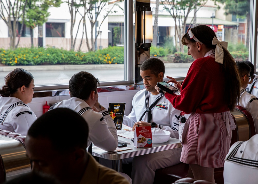 Sailors eat lunch at Ruby's Diner