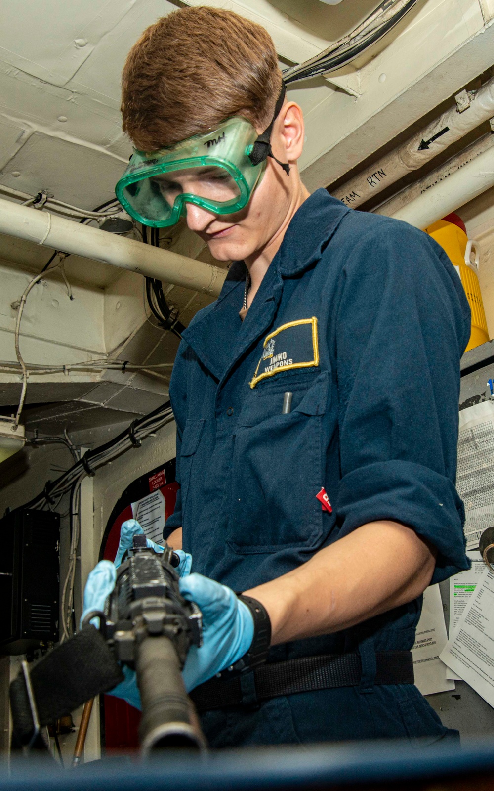 Sailor Performs Pre-Fire Maintenance On Firearm