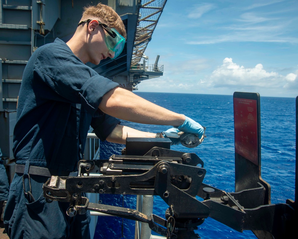 Sailor Performs Anti-Corrosion Maintenance On Gun Mount