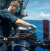 Sailor Performs Anti-Corrosion Maintenance On Gun Mount