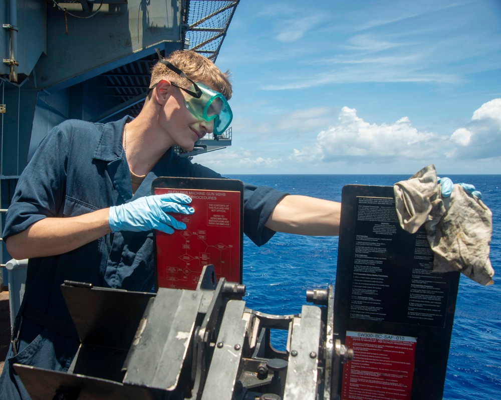 Sailor Performs Anti-Corrosion Maintenance On Gun Mount