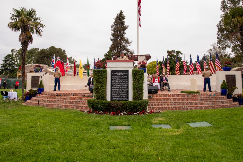 Sailors and Marine place flag at service members graves