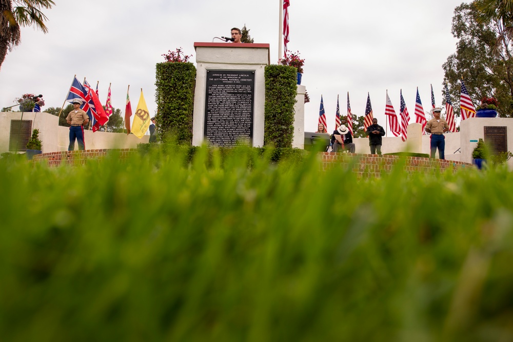 Sailors and Marine place flag at service members graves